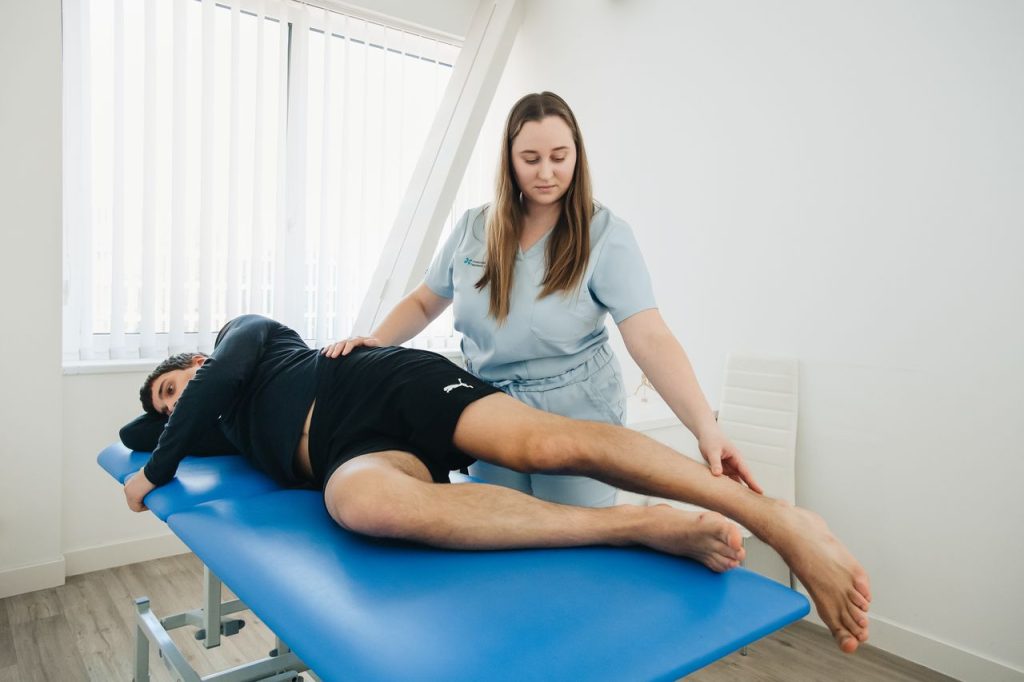 Home Therapist treating a patient on a treatment table