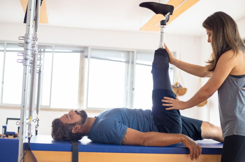 Home Therapist helping a patient stretch after surgery