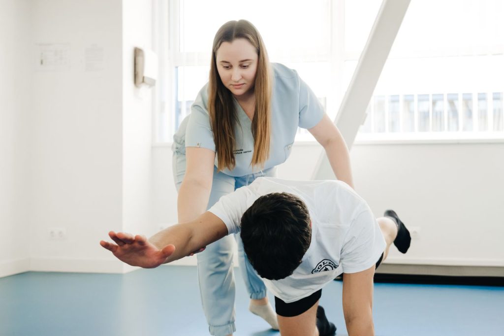 Home Therapist guiding a patient through a rehabilitation exercise